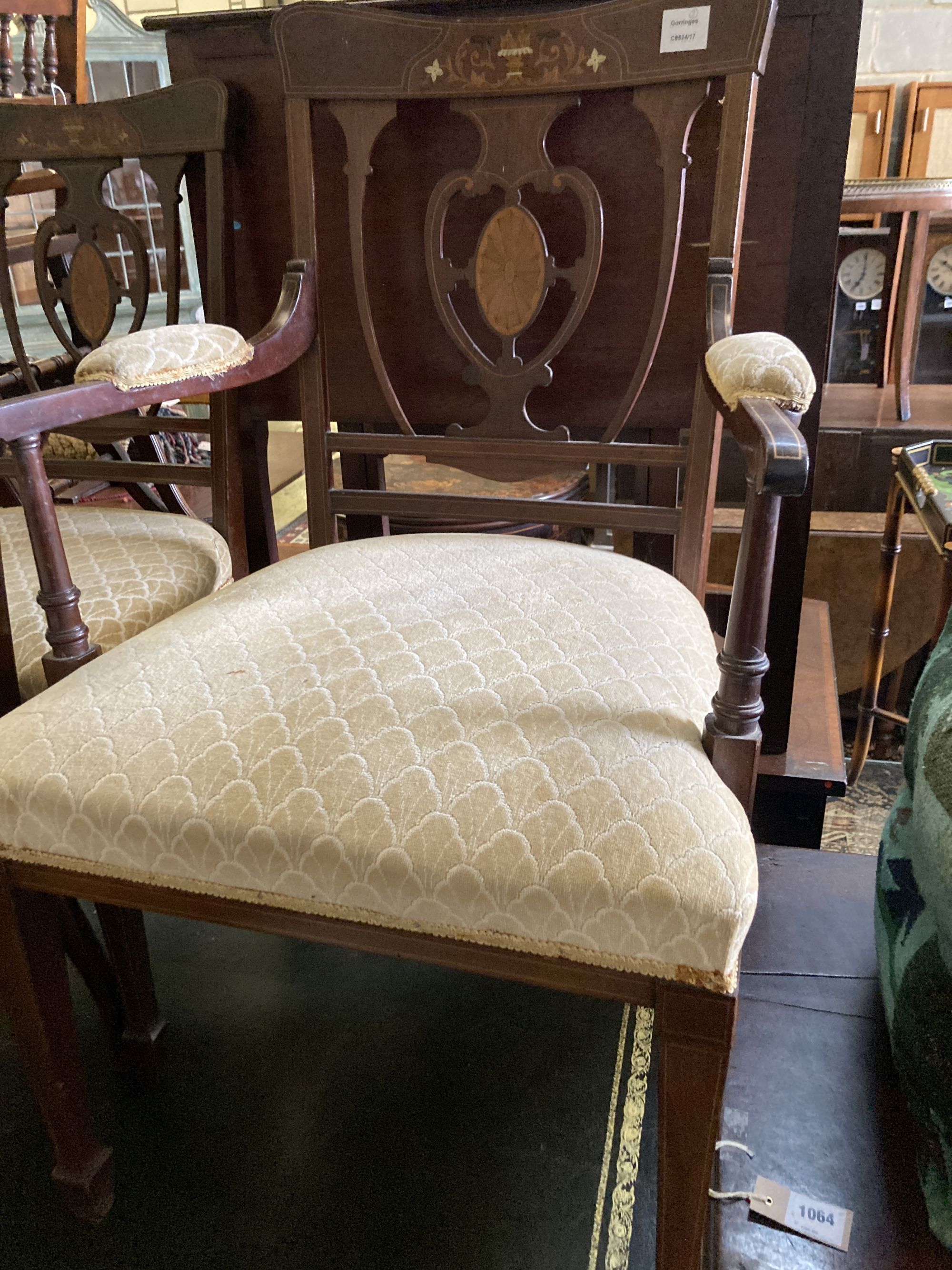 A pair of Edwardian inlaid mahogany elbow chairs and two matching single chairs